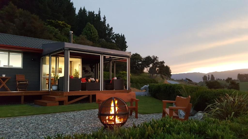 a tiny house with a solarium and a fire light at Rocky Ridge Cottage in Takaka