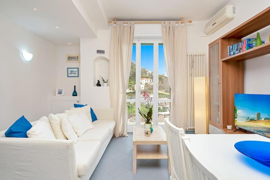 a living room with a white couch and a table at Lerici 5 Terre casa il Bivio 1989 in Lerici