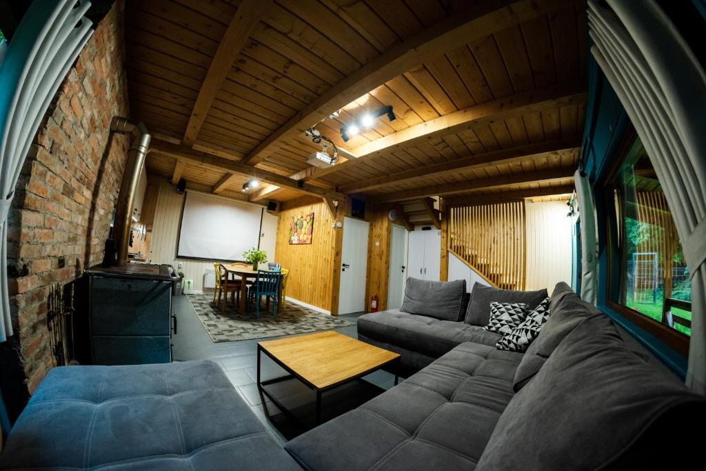 a living room with a couch and a table at ZADA nature lounge in Cluj-Napoca