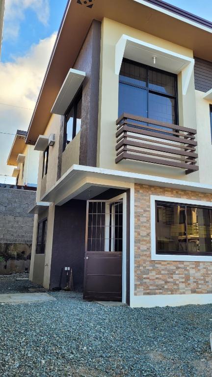 a house with a front door and a balcony at Camilyn Home Stay in General Trias