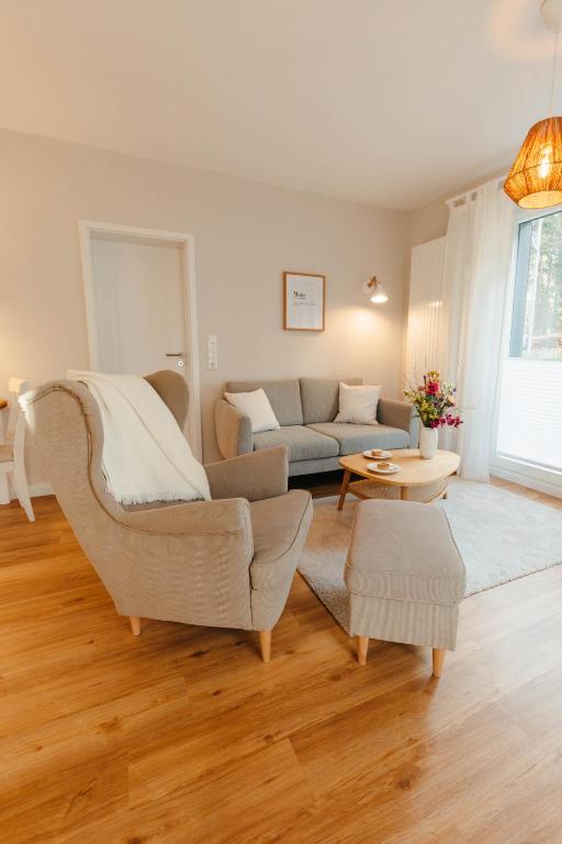a living room with a couch and a chair at Fine Stuuv in Ratzeburg
