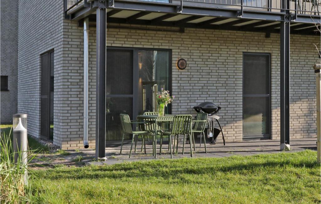 a patio with a table and chairs in front of a building at Pet Friendly Apartment in Lembruch