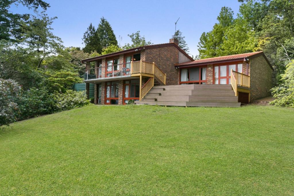 a house with a large lawn in front of it at Solitary View in Wentworth Falls