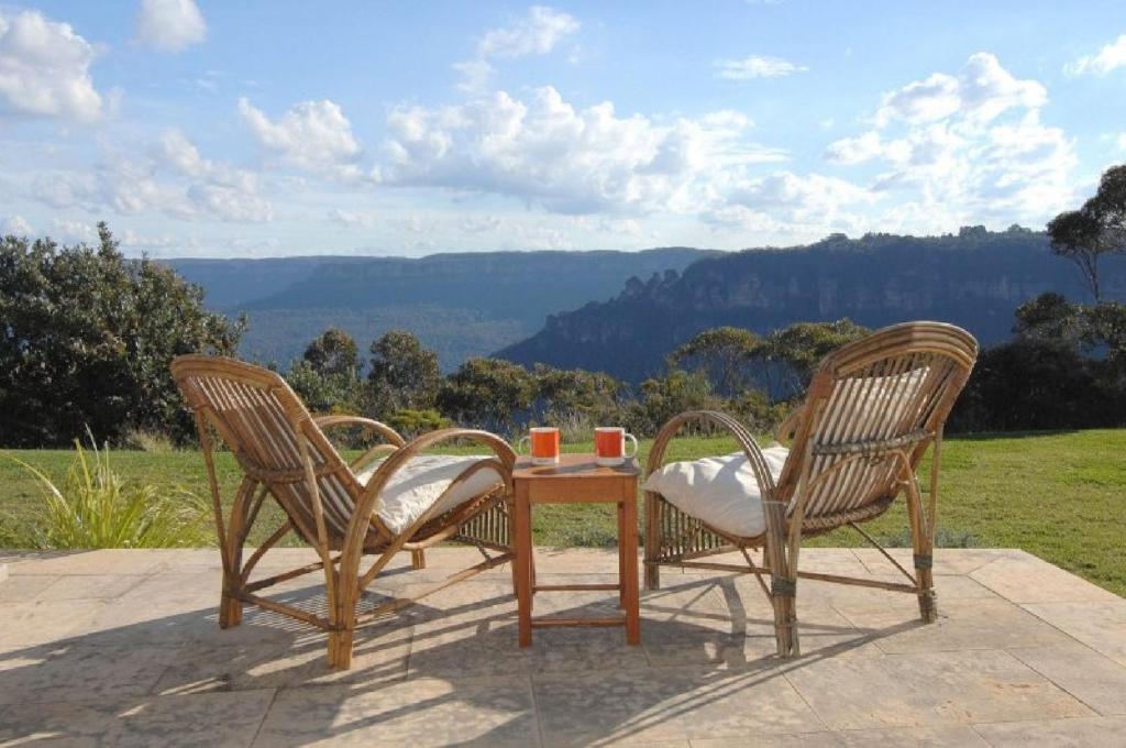 two chairs and a table with two cups on it at Highview in Leura