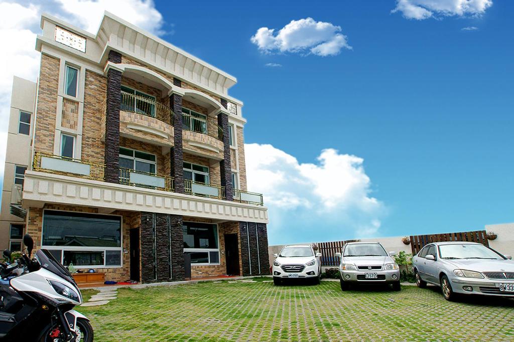 a group of cars parked in front of a building at Knight Inn in Taitung City