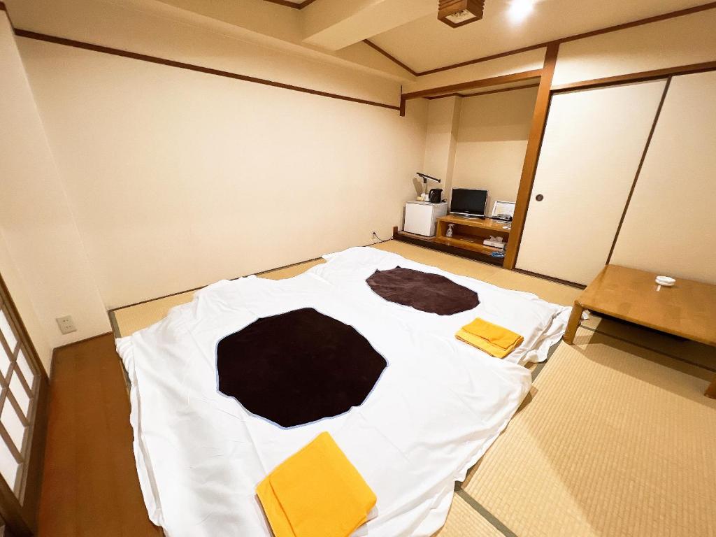 Postel nebo postele na pokoji v ubytování ビジネスホテル ごとう＠ＮＥＴ