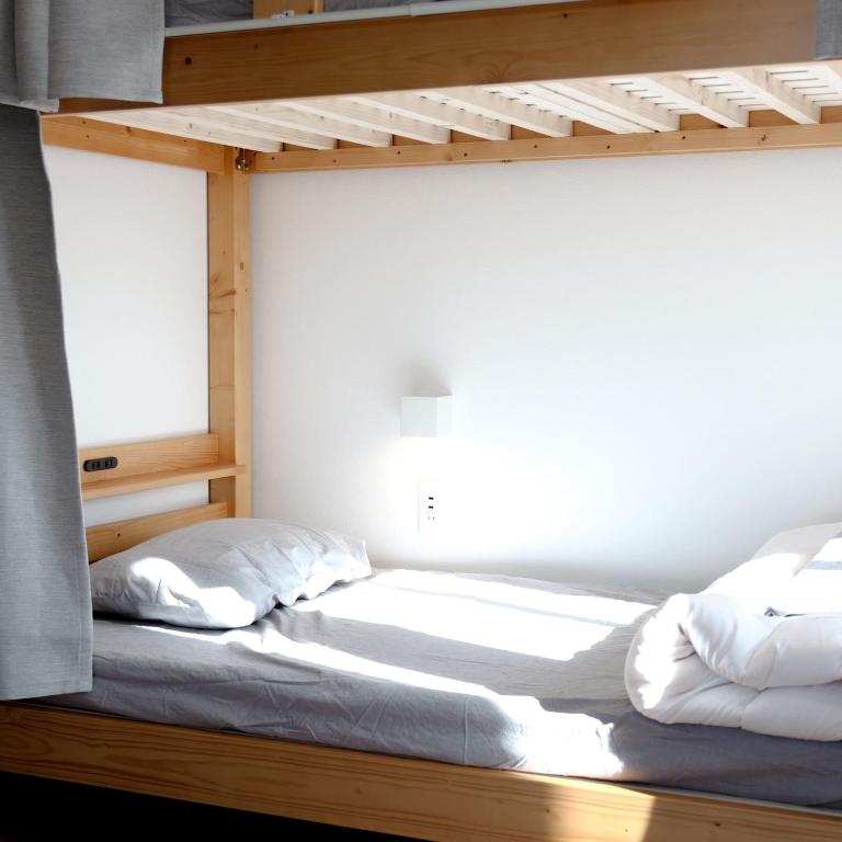 Postel nebo postele na pokoji v ubytování Matoi Hostel & Bar