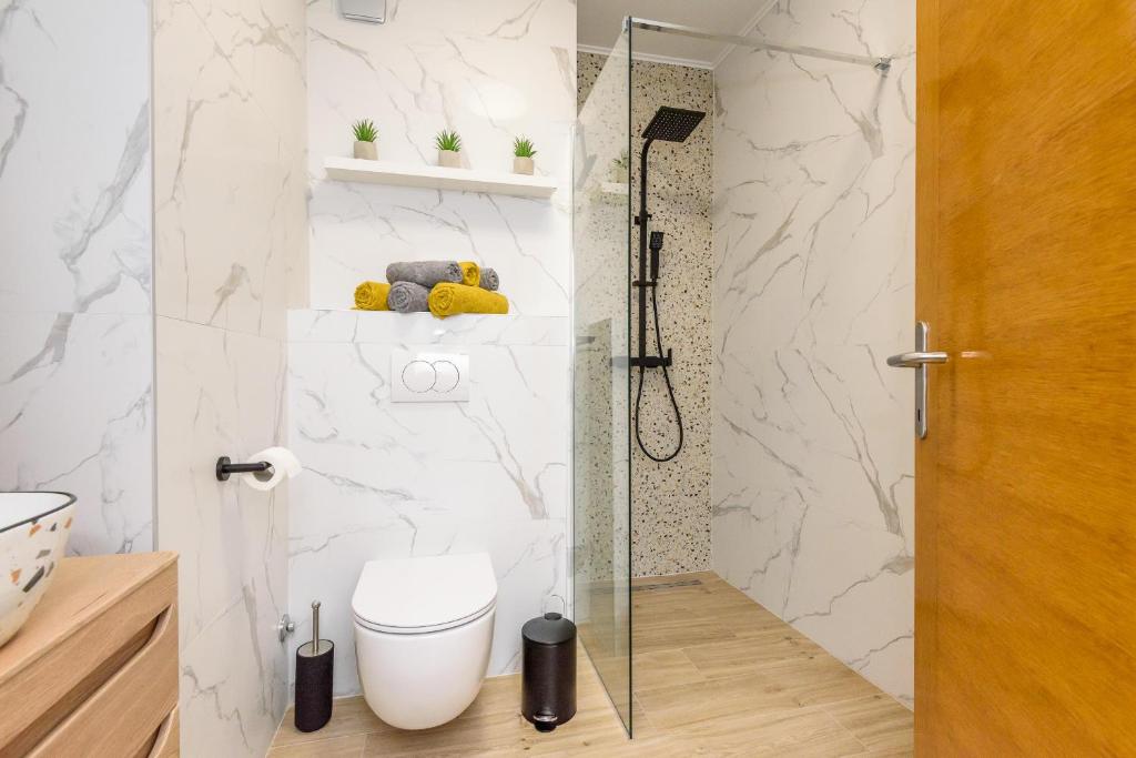 a bathroom with a shower and a toilet in it at Apartman Angie in the centre of Metkovic in Metković