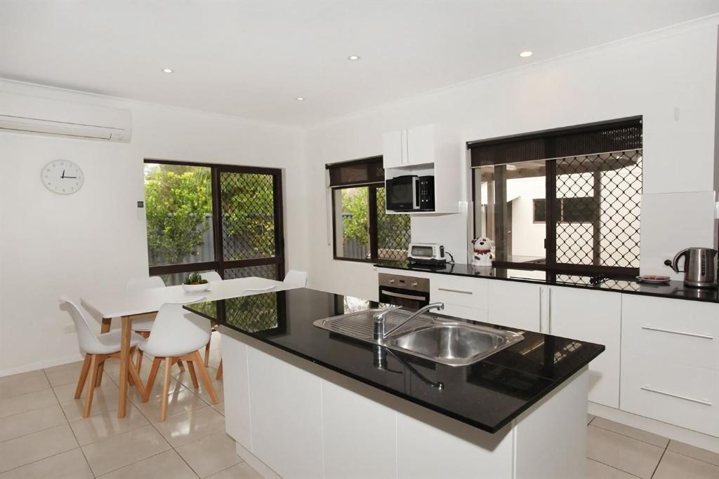 a kitchen with a sink and a counter top at 6 Petrie Avenue in Marcoola