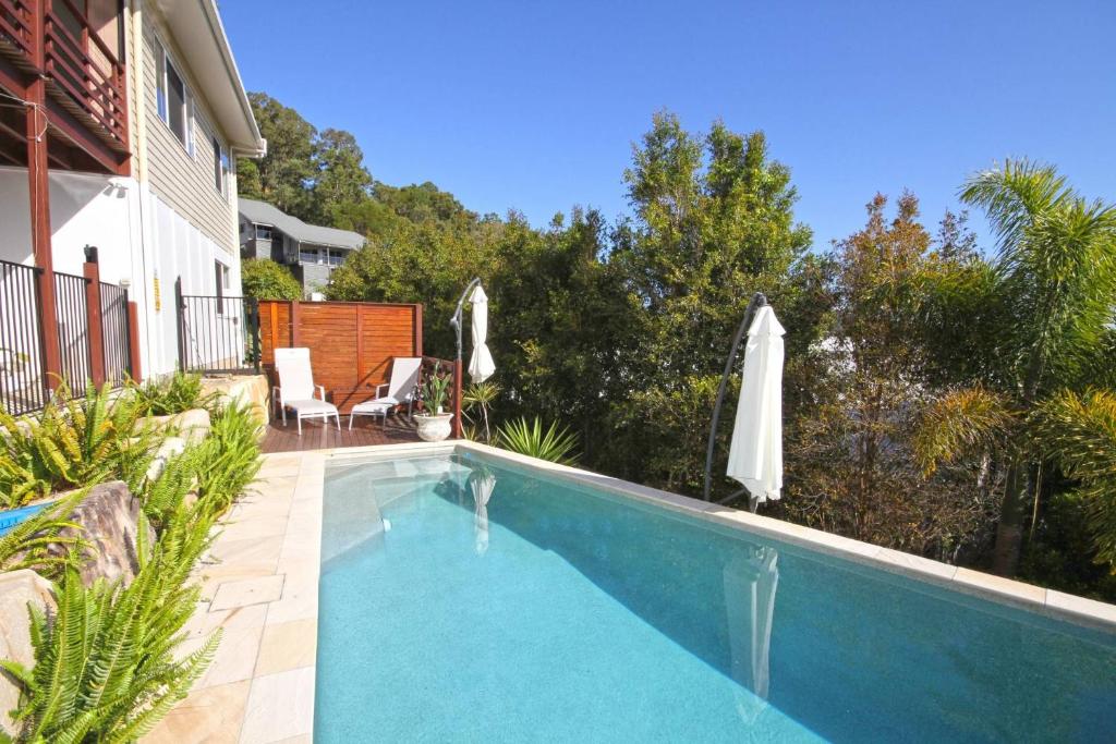 a swimming pool in the backyard of a house at Stunning Home With Spectacular Views in Coolum Beach