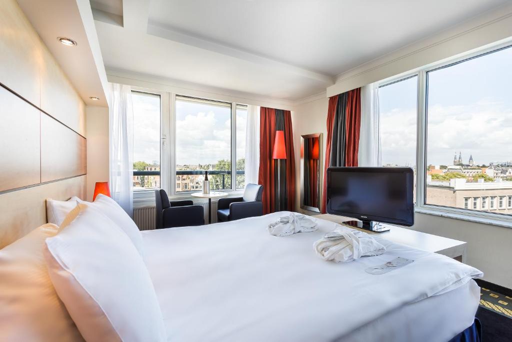 Een bed of bedden in een kamer bij Hotel Die Port van Cleve