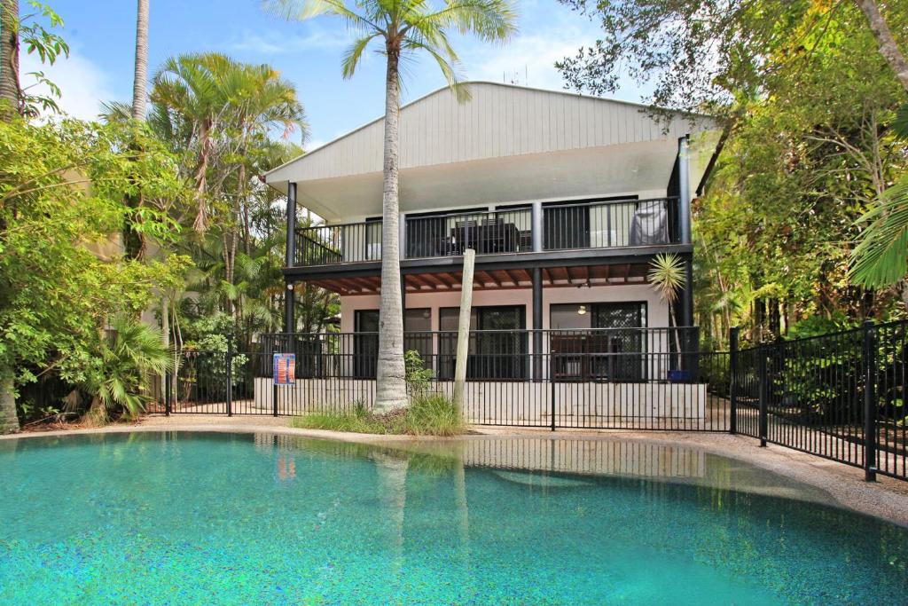 a house with a swimming pool in front of a house at 8 Springfield Avenue in Coolum Beach