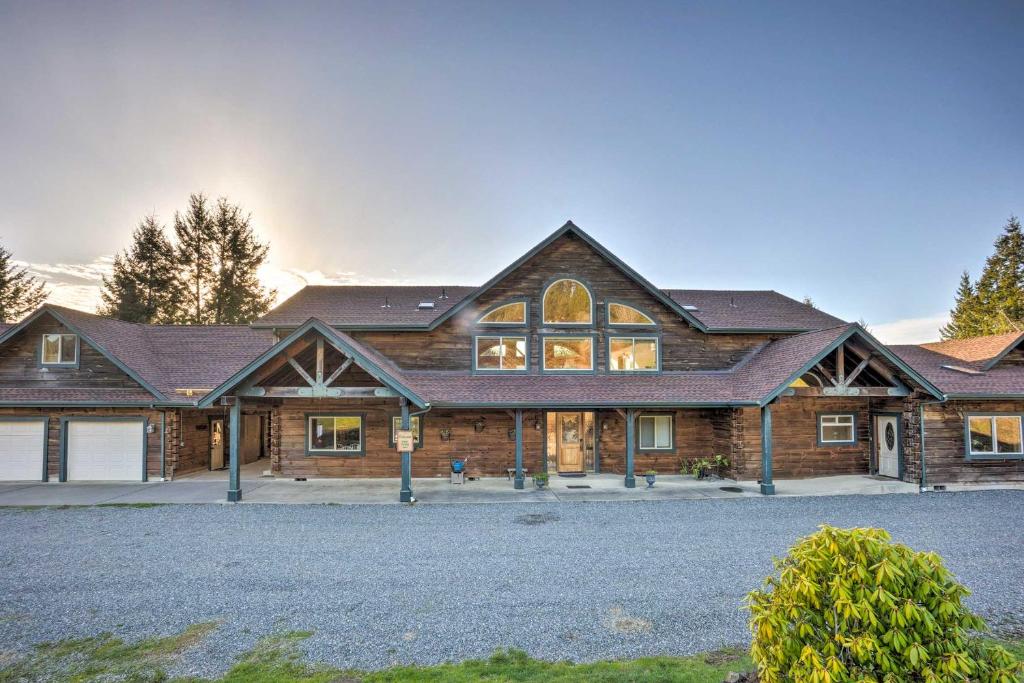 a large wooden house with a driveway at Brookings Vacation Rental Lodge on 88 Acres! in Brookings