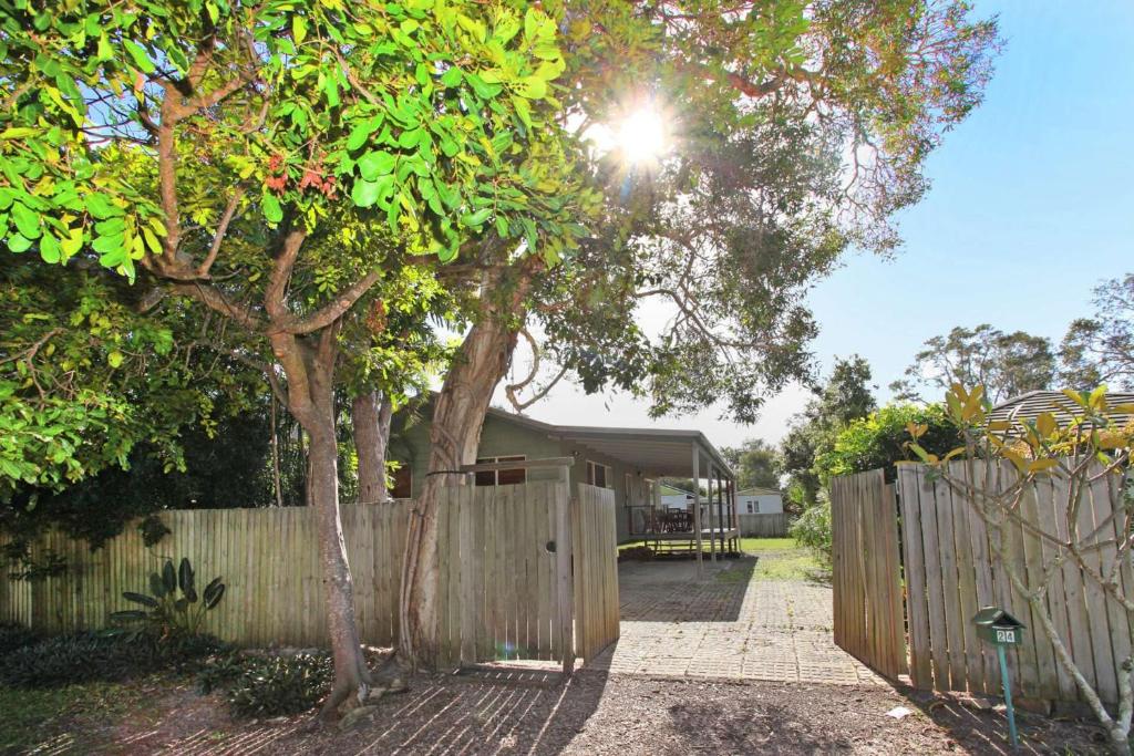 a fence in front of a yard with a house at 24 Sundew Street in Mudjimba