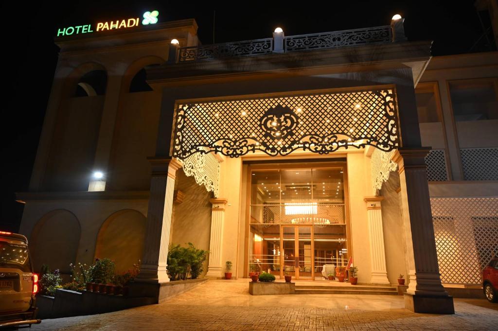 an entrance to a store at night with lights at HOTEL PAHADI in Rourkela