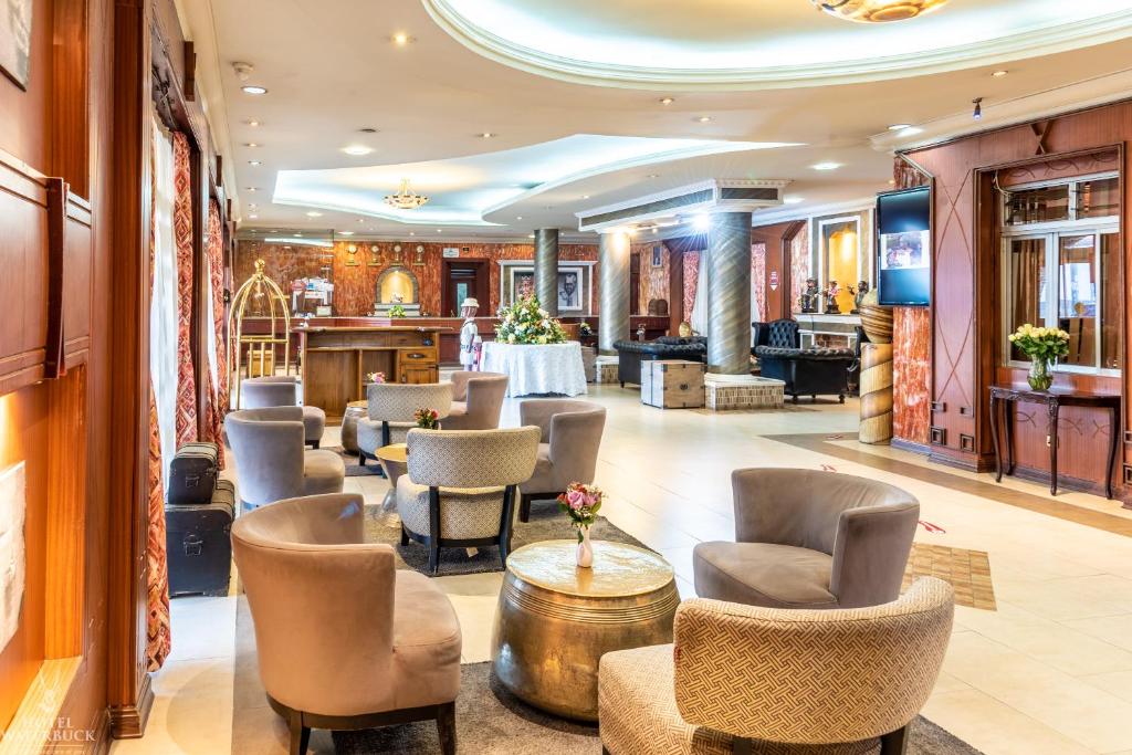 a lobby of a hotel with chairs and tables at Hotel Waterbuck in Nakuru