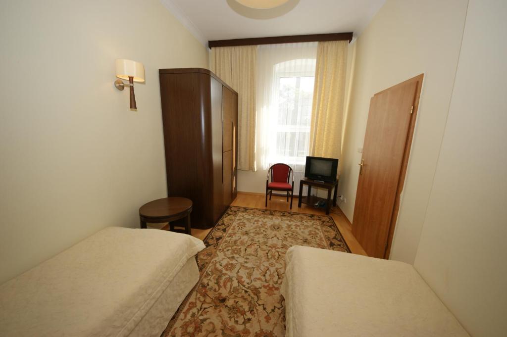 Postel nebo postele na pokoji v ubytování Hotel Zamkowy