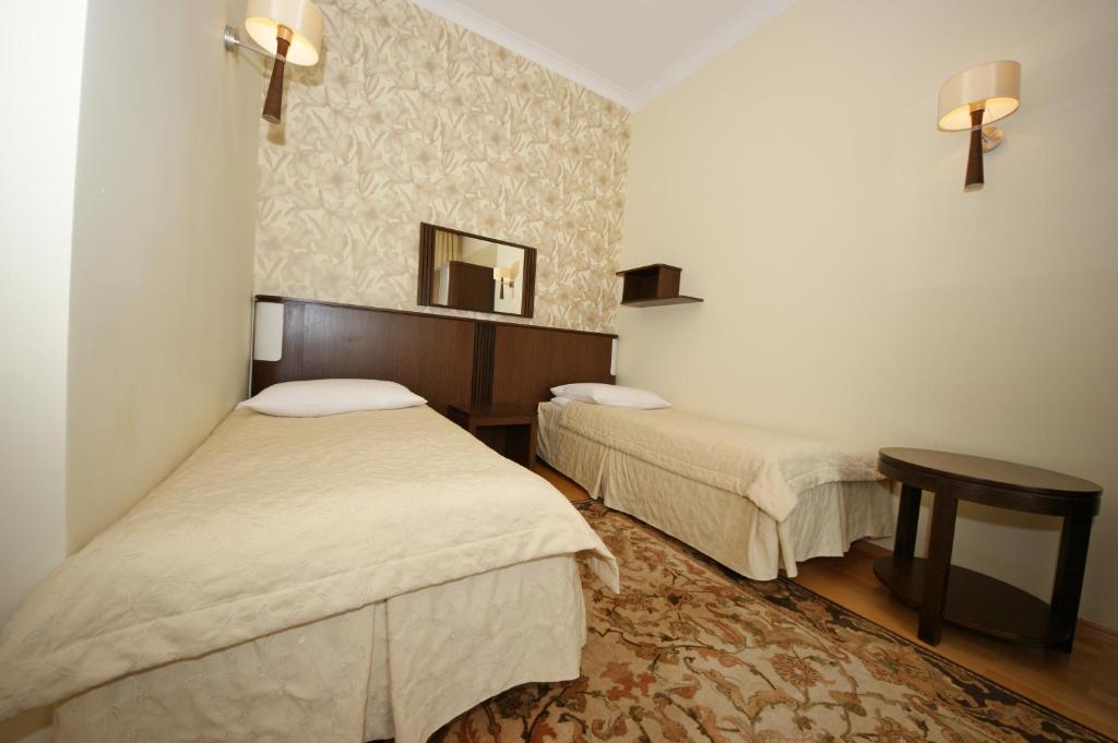 Postel nebo postele na pokoji v ubytování Hotel Zamkowy