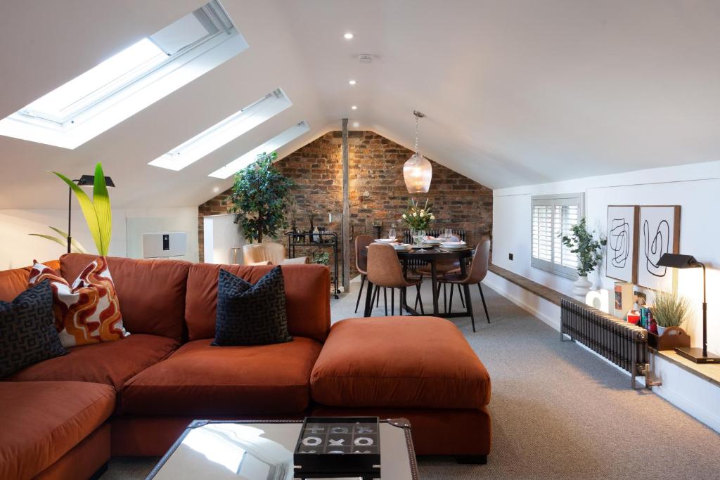 a living room with a couch and a dining room at The Workshop in York