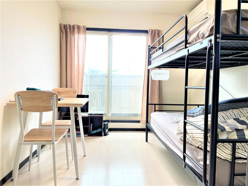a dorm room with a bunk bed and a desk at Credo Maison Kamakura 202 in Kamakura