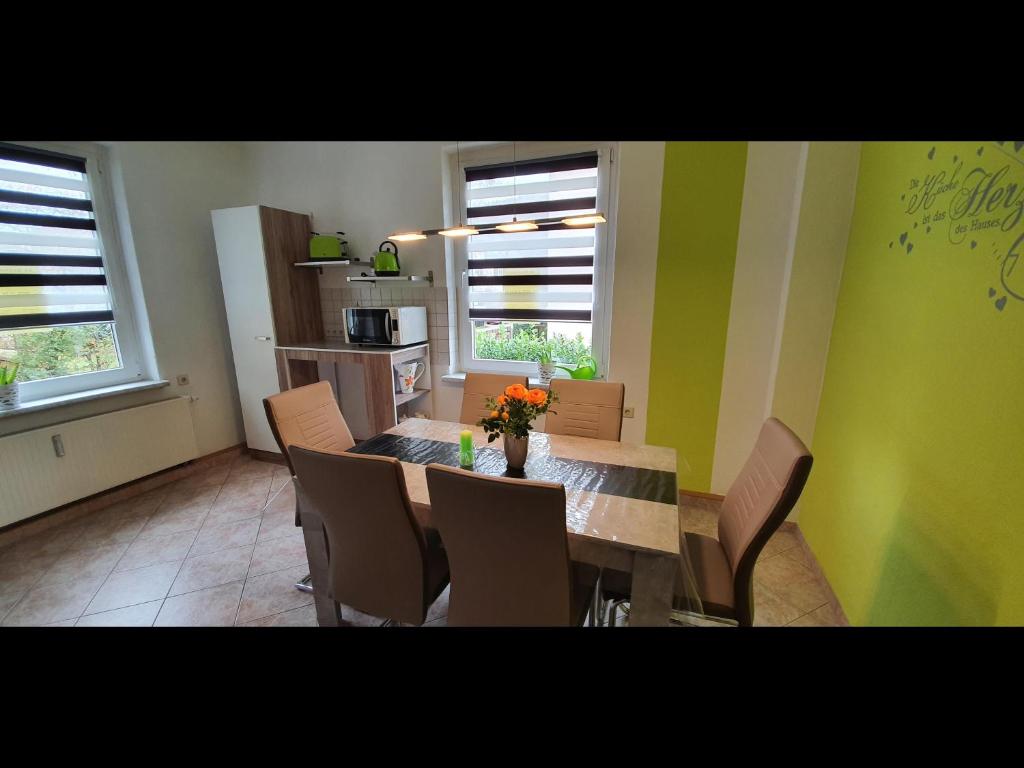 jadalnia ze stołem i krzesłami oraz kuchnia w obiekcie NEU! Ferienwohnung Unger w mieście Schwarzenberg