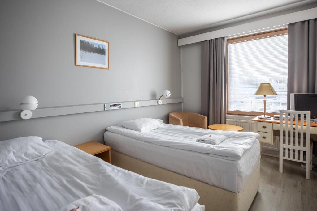 Postel nebo postele na pokoji v ubytování Hotel Karhu