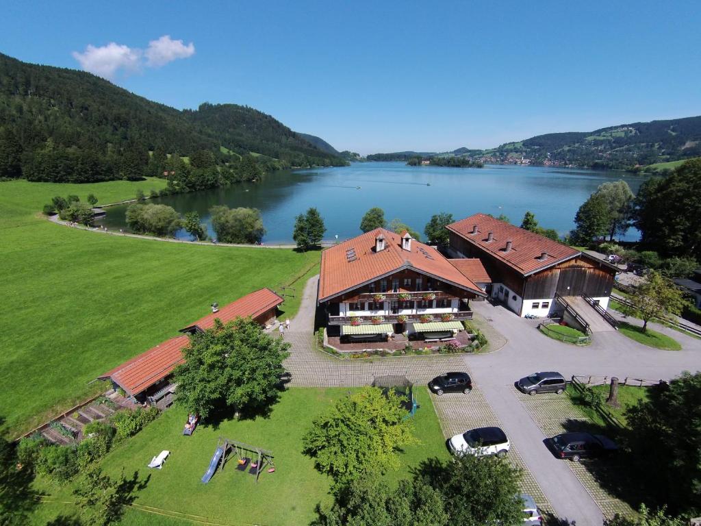 an aerial view of a house with a lake at Der Anderlbauer am See in Schliersee