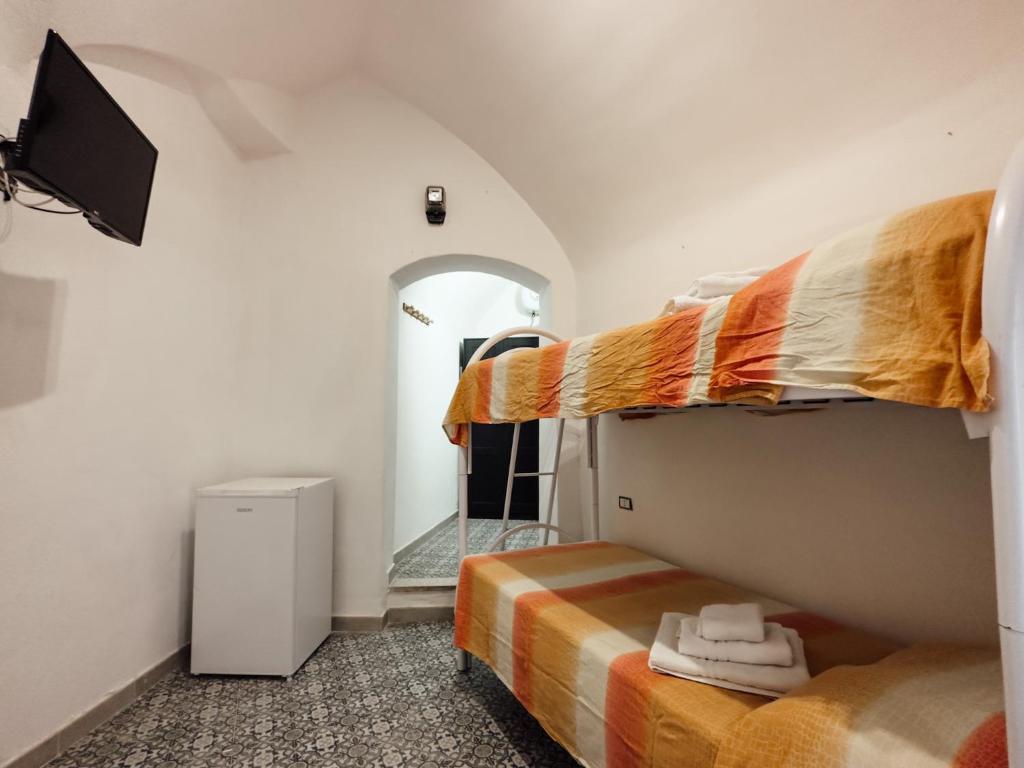 a room with two bunk beds and a mirror at Dimora Garibaldi Rooms - center-Wi-fi in Gallipoli