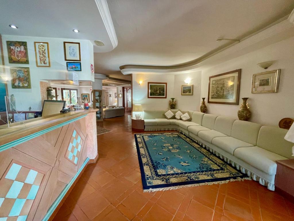 a living room with a couch and a rug at Hotel Stefania Boutique Hotel by the Beach in Olbia