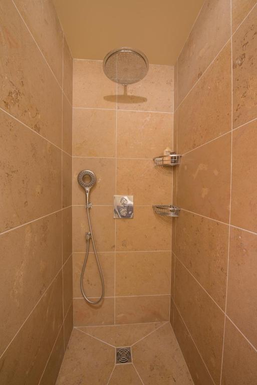 a bathroom with a shower with a shower head at Chez Joseph - Au coeur des vignes de Saint-Romain in Saint-Romain