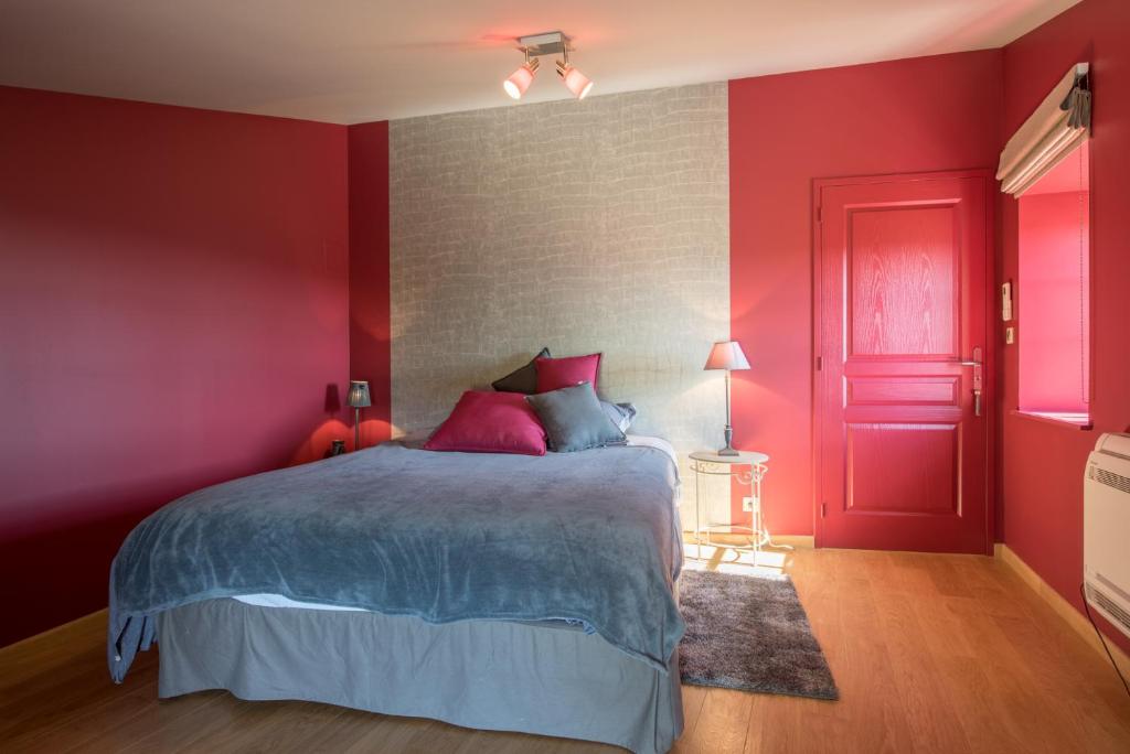 a red bedroom with a bed and a red door at Chez Joseph - Au coeur des vignes de Saint-Romain in Saint-Romain