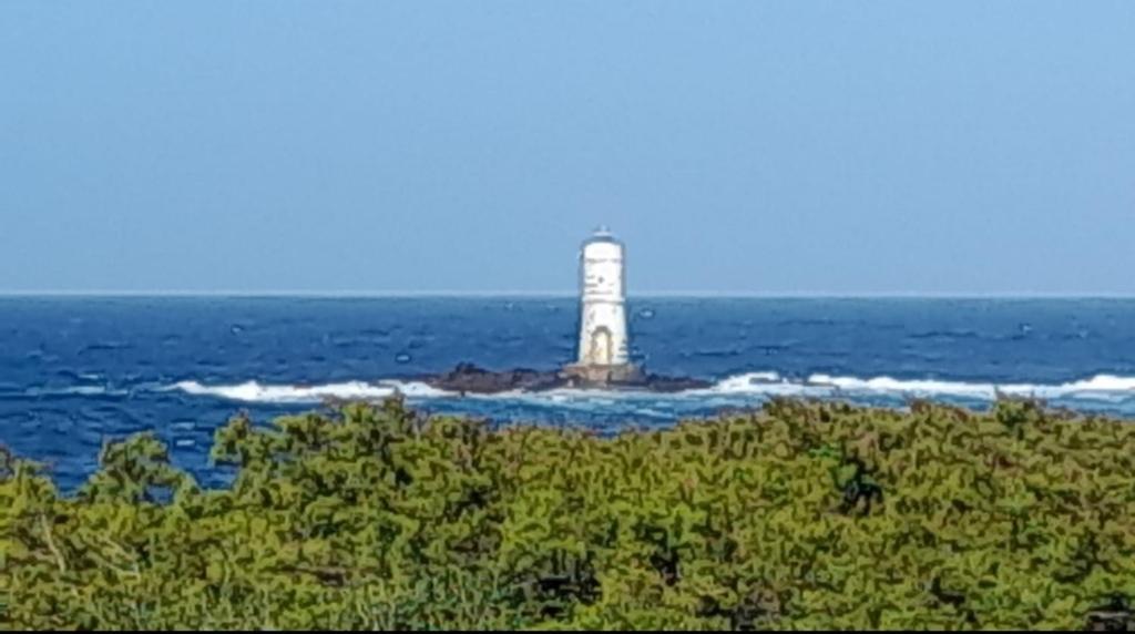 a lighthouse on a island in the ocean at Casa scopelliti in Calasetta