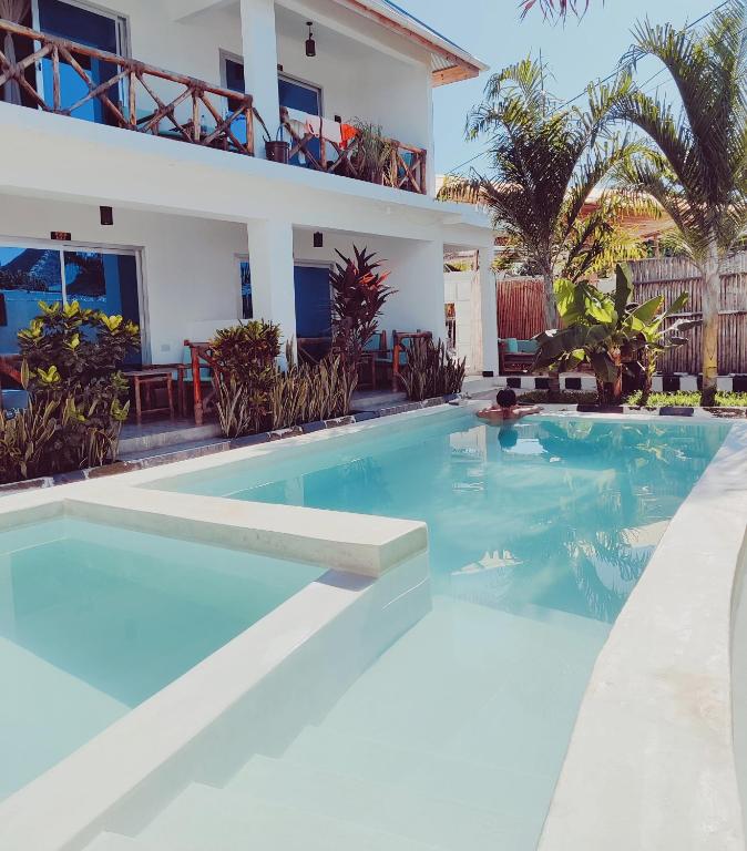 a swimming pool in front of a house at Hakuna Matata Boutique in Paje