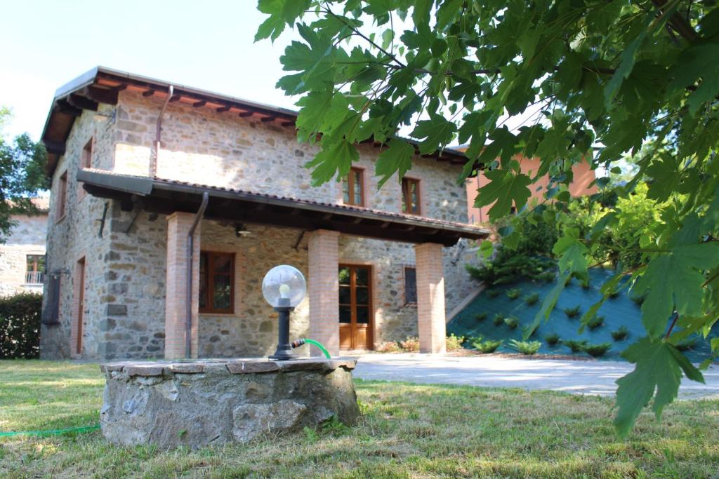 a stone house with a satellite dish in front of it at Agriturismo La Locanda del Cardinale in Poggio