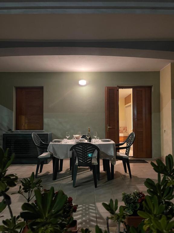 a dining room with a table and two chairs at Sunway Apartments 2 in Alghero