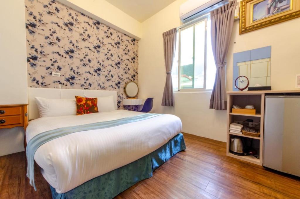 Postel nebo postele na pokoji v ubytování Sweet B&B 幸福微甜民宿