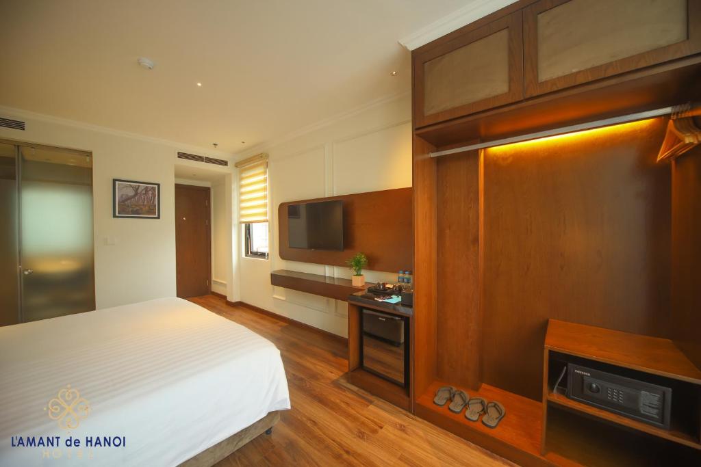 Postel nebo postele na pokoji v ubytování L'amant de Hanoi Hotel - khách sạn Lamant de Hà Nội