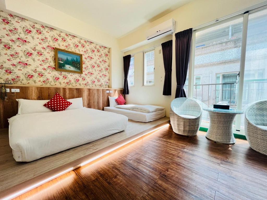 Postel nebo postele na pokoji v ubytování Sweet B&B 幸福微甜民宿