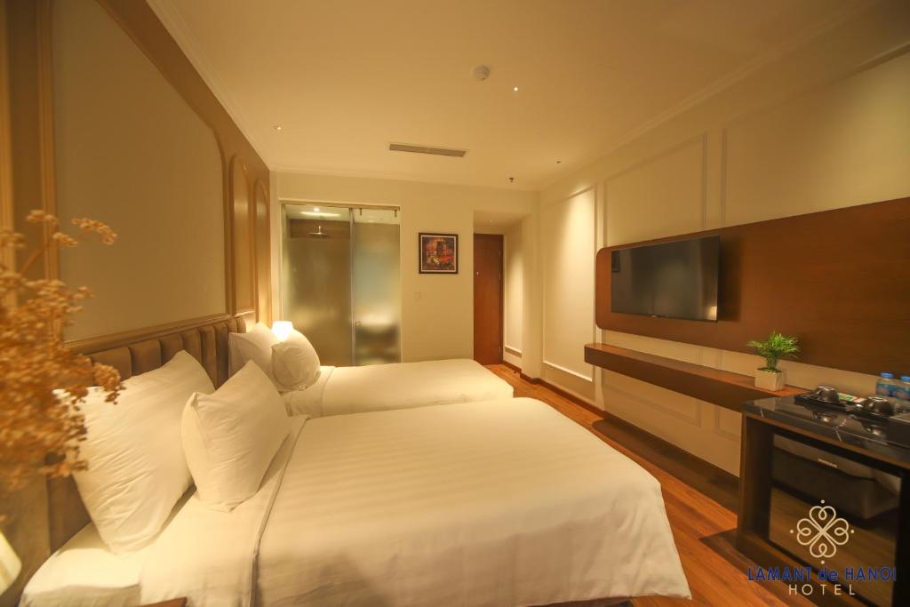Postel nebo postele na pokoji v ubytování L'amant de Hanoi Hotel - khách sạn Lamant de Hà Nội