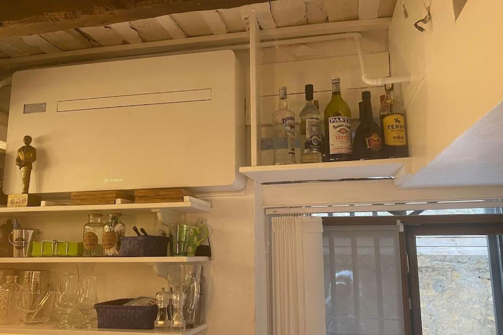a kitchen with bottles of alcohol on the wall at historic authentic atmosphere - high-end luxury décor in Le Cannet