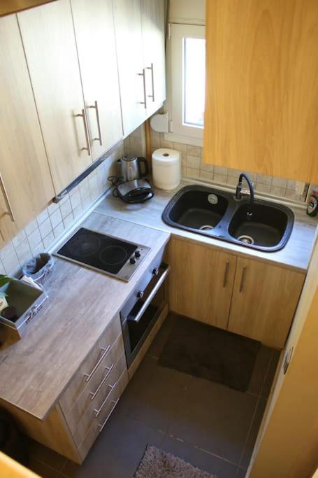 a small kitchen with a sink and a stove at Fotini&#39;s home in Gouvia