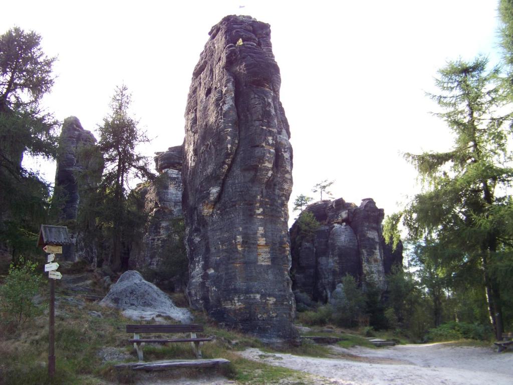 a large rock formation with a bench in front of it at Tisá 488 in Tisá