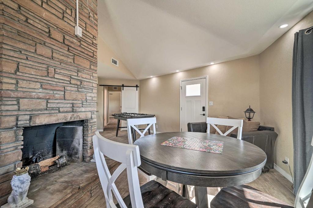 a living room with a table and a fireplace at Family Friendly Vacation Rental with Gas Grill! in Lake Havasu City