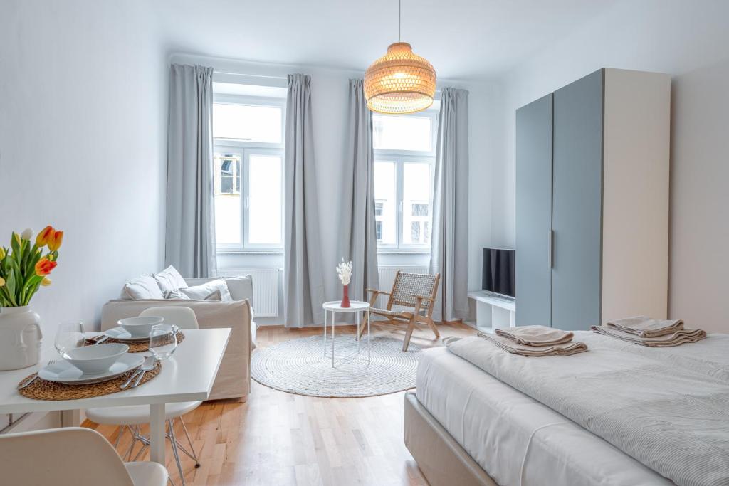 a living room with a large bed and a couch at City Apartments Vienna in Vienna
