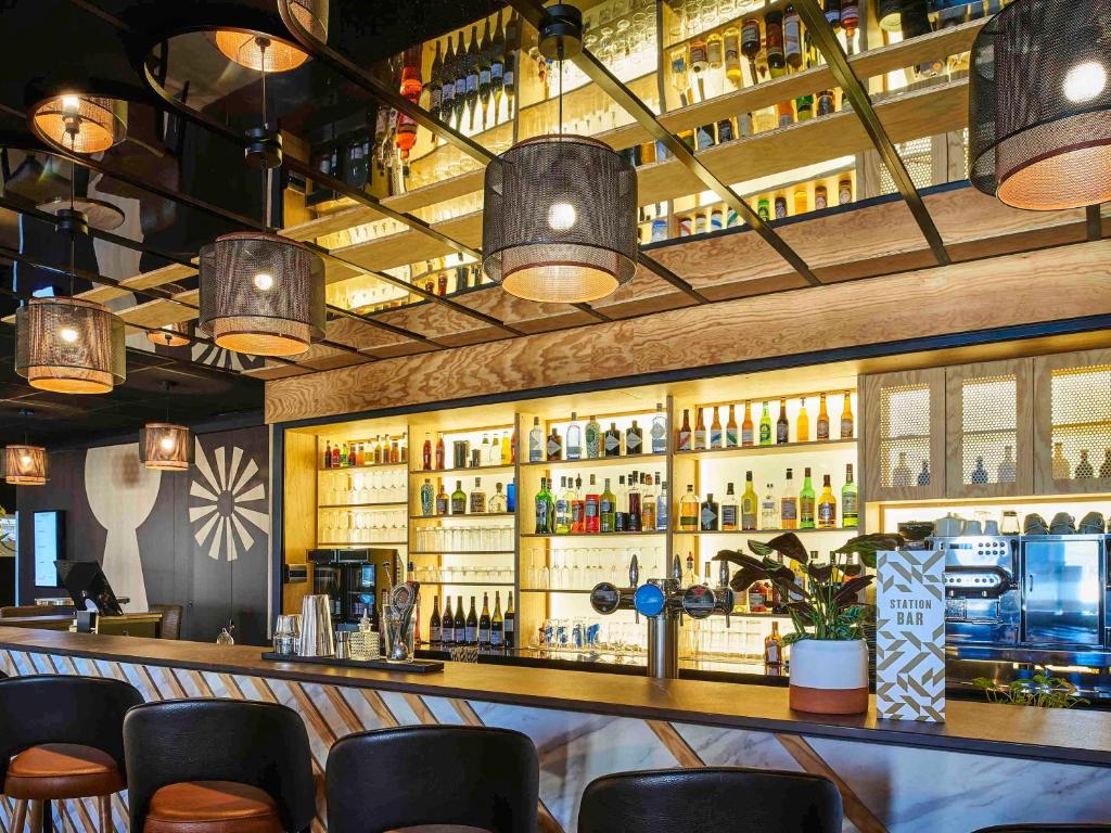 a bar with a lot of bottles of alcohol at Mercure Paris Gare De Lyon TGV in Paris