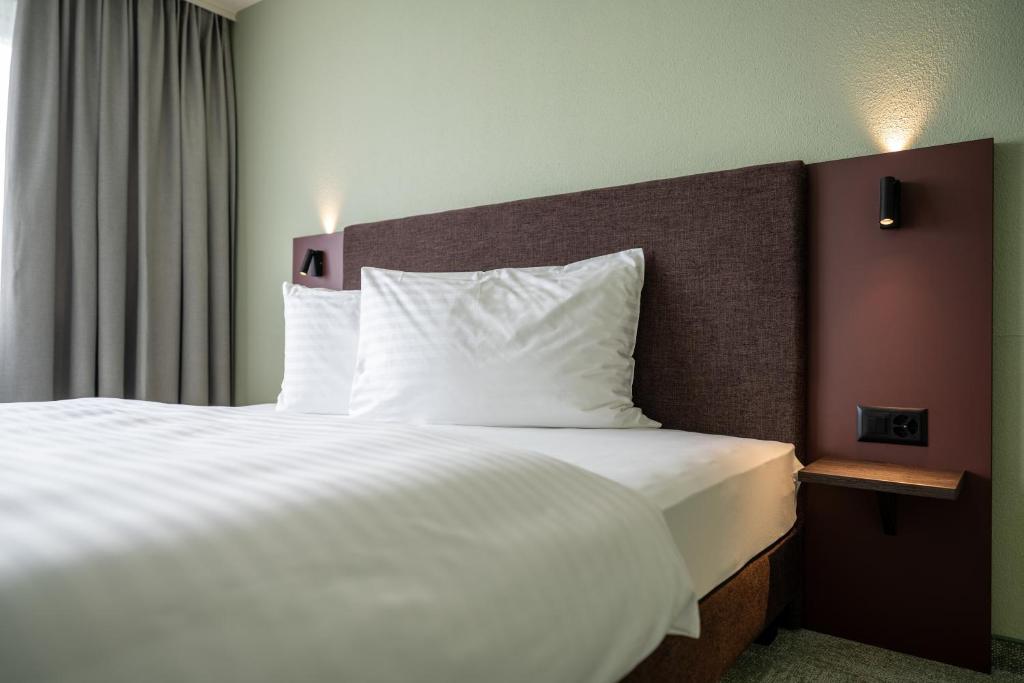 Postel nebo postele na pokoji v ubytování b-smart hotel Schönenwerd
