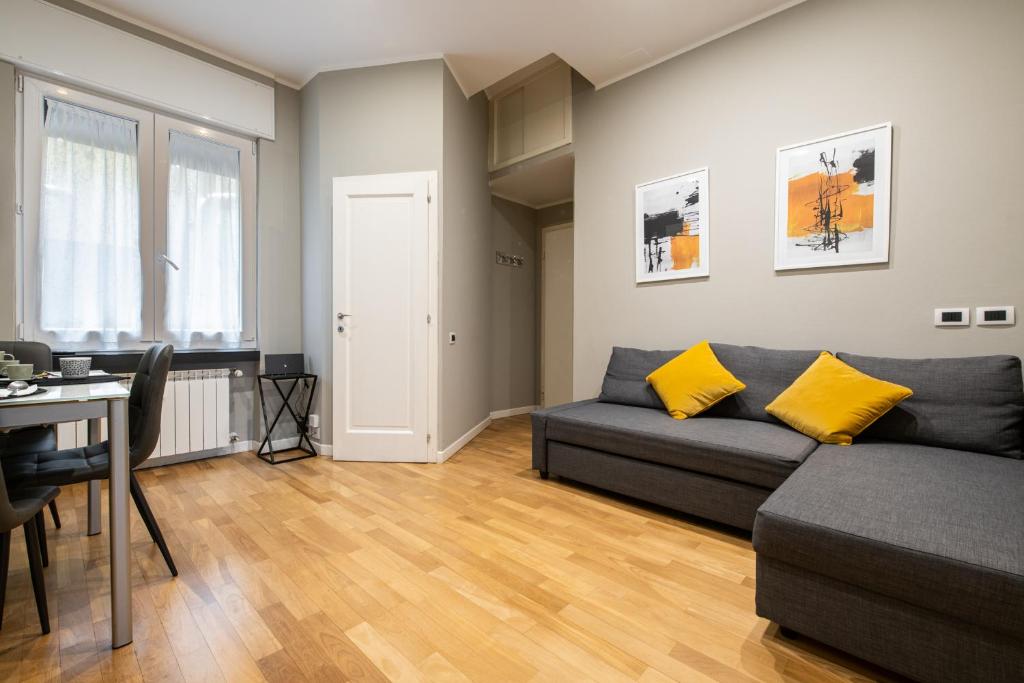a living room with a couch and a table at Maison Marconi in Bologna