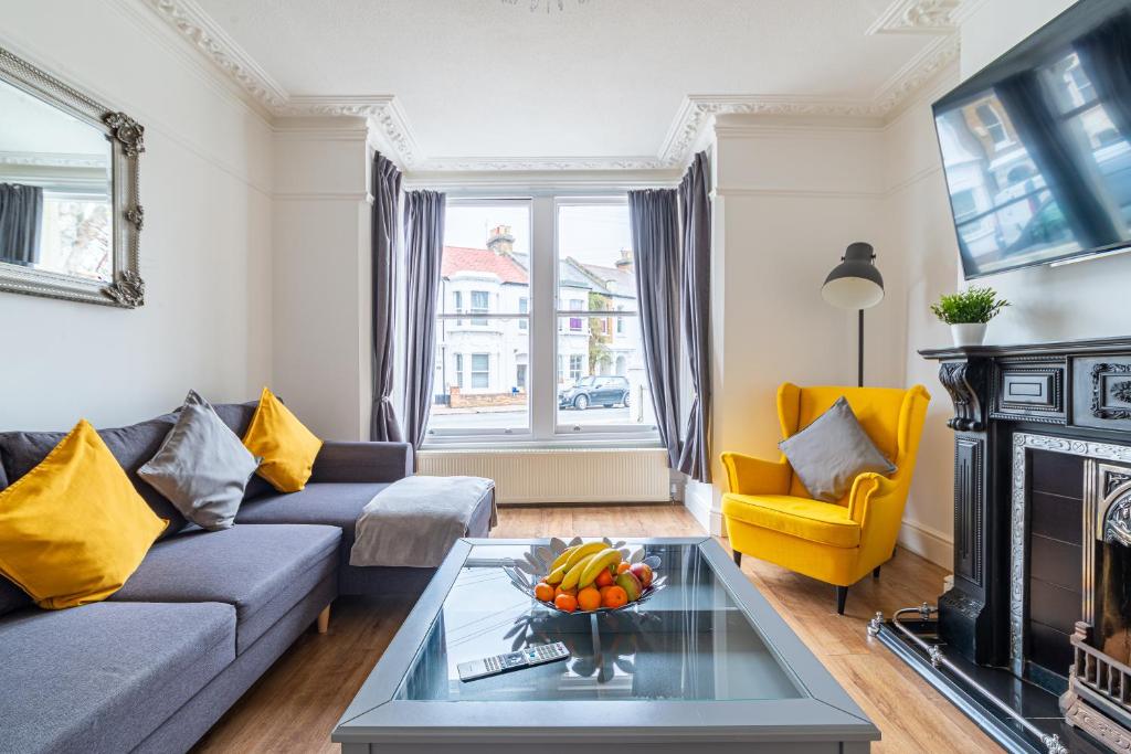 a living room with a couch and a fireplace at 2 Bedroom Apartment Close to Beach & Town Centre in Southend-on-Sea