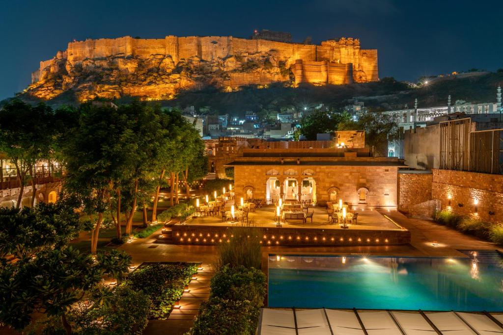 a hotel with a view of the castle at night at RAAS Jodhpur in Jodhpur