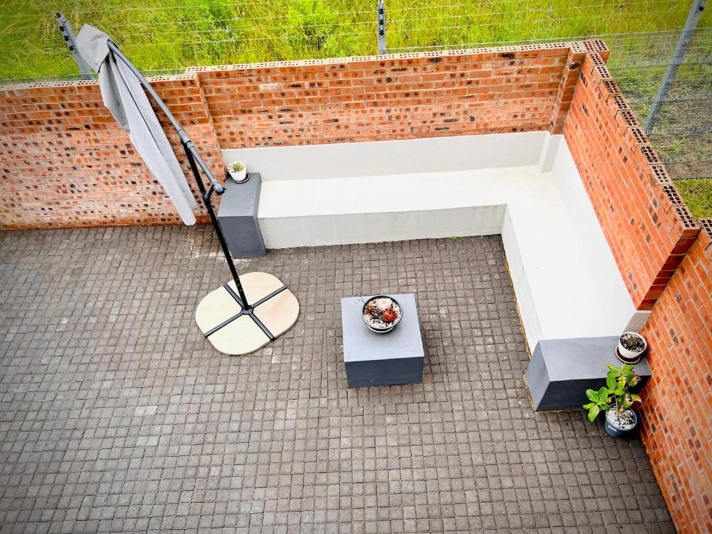 an overhead view of a patio with a table and an umbrella at No Load-Shedding Holiday Home in Mataffin